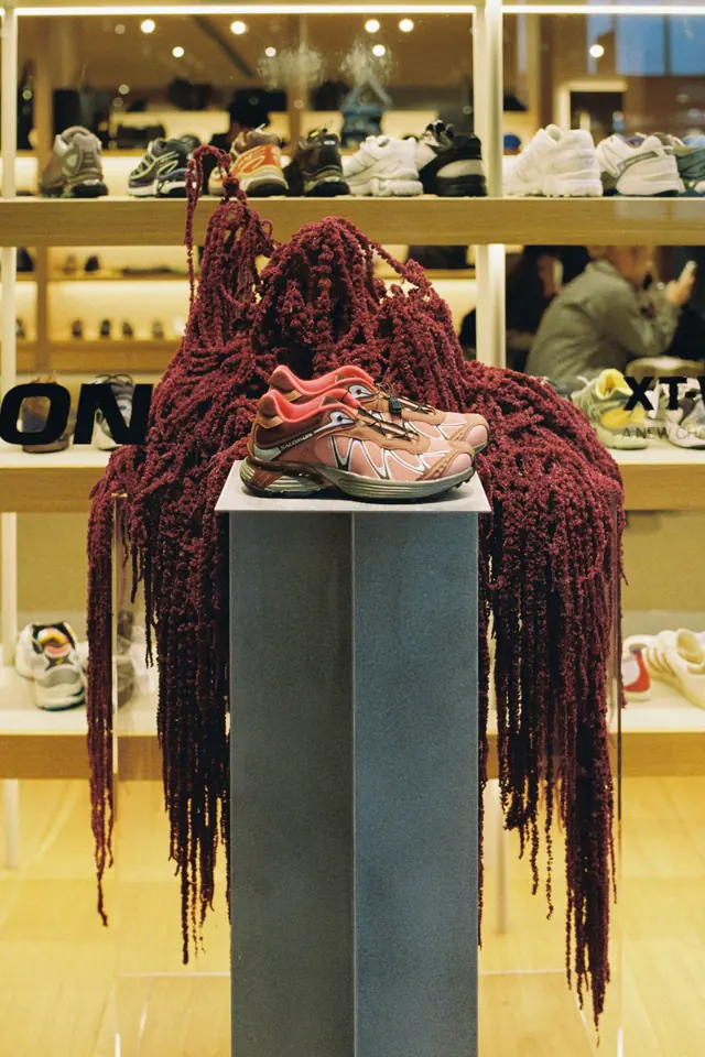 Cascading dark red amaranthus on a plinth in a retail store