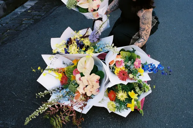 Wrapped XFLOS bouquets laid out on the street, ready for delivery